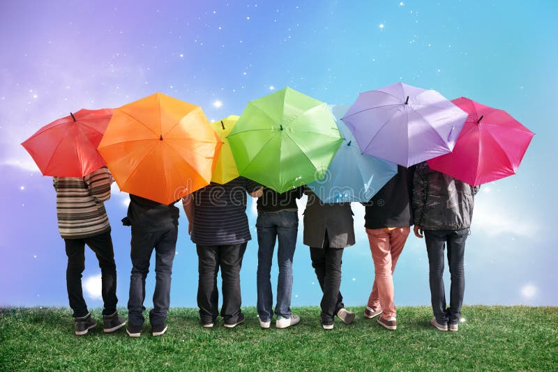Seven friends with rainbow color umbrellas on meadow collage. Seven friends with rainbow color umbrellas on meadow collage