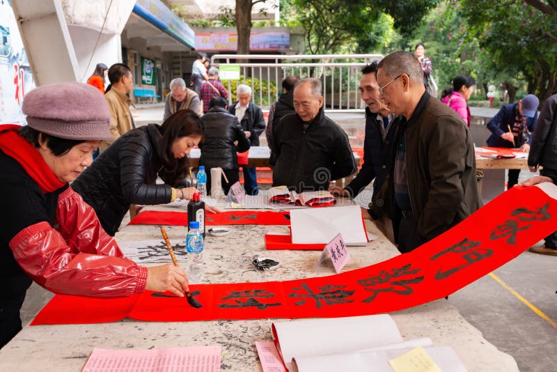 People writing Chinese new year scrolls. ZhongShan China-Jan 18,2019:People writing Chinese new year scrolls royalty free stock photo People writing Chinese new year scrolls. ZhongShan China-Jan 18,2019:People writing Chinese new year scrolls royalty free stock photo