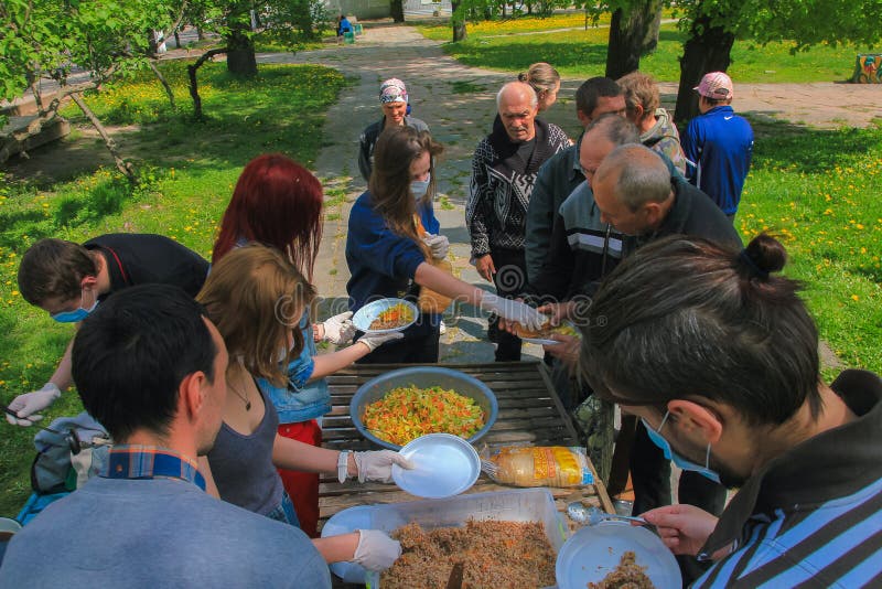Zhytomyr, UKRAINE - May 21, 2017: Some anarchist activists at Food Not Bombs campaign feeding the homeless in Zhytomyr. Zhytomyr, UKRAINE - May 21, 2017: Some anarchist activists at Food Not Bombs campaign feeding the homeless in Zhytomyr