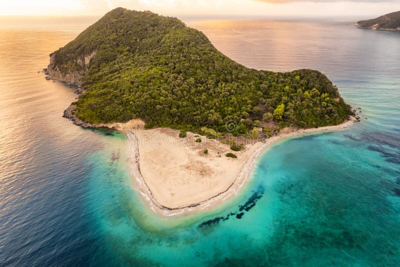 Aerial view of Marathonisi Island at sunrise near Zakynthos island in Greece. Marathon island at sunrise in Zante, Ionian sea. Idyllic beach with turquoise sea water. Aerial view of Marathonisi Island at sunrise near Zakynthos island in Greece. Marathon island at sunrise in Zante, Ionian sea. Idyllic beach with turquoise sea water