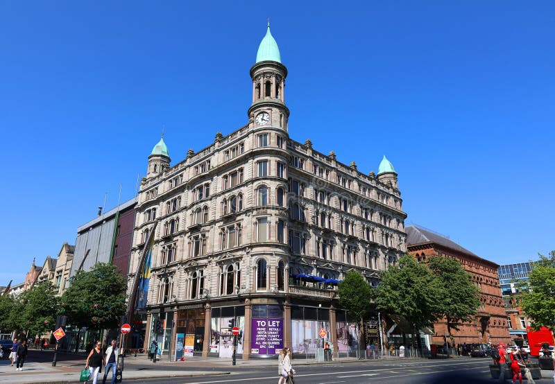 BELFAST NORTHERN IRELAND UNITED KINGDOM 06 03 2023: Green copper ogee dome and tower clock on old Robinson and Cleavers department store in belfast designed by Young and Mackenzie. BELFAST NORTHERN IRELAND UNITED KINGDOM 06 03 2023: Green copper ogee dome and tower clock on old Robinson and Cleavers department store in belfast designed by Young and Mackenzie