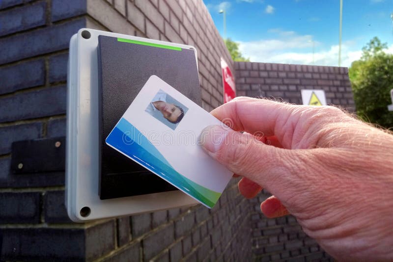 Green light on an electronic card reader, showing a man being allowed access to a secure location. Green light on an electronic card reader, showing a man being allowed access to a secure location.