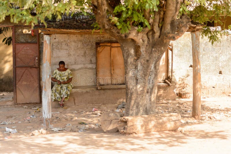Unidentified Senegalese woman sits beside the road near her hou royalty free stock images Unidentified Senegalese woman sits beside the road near her hou royalty free stock images