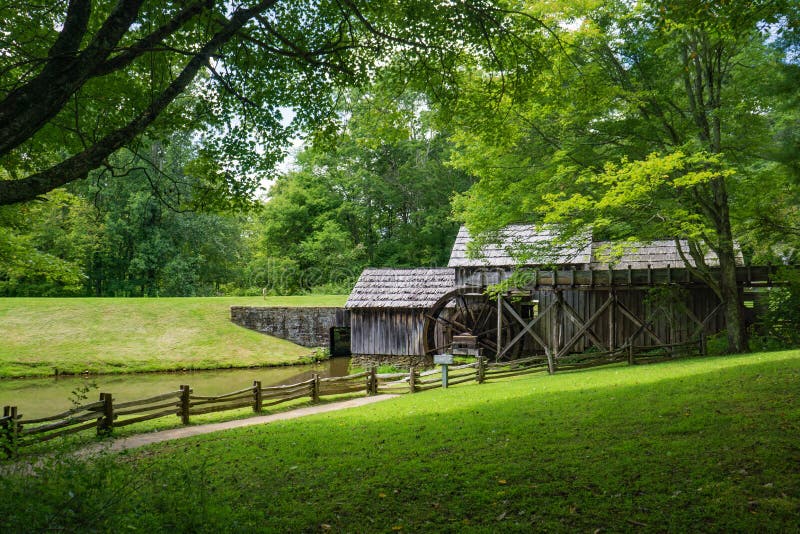 Floyd County, VA – August 10th: Side view of Mabry Mill framed by trees located on the Blue Ridge Parkway in Floyd County on August 10th, 2018, Copper Hill, Virginia, USA. Floyd County, VA – August 10th: Side view of Mabry Mill framed by trees located on the Blue Ridge Parkway in Floyd County on August 10th, 2018, Copper Hill, Virginia, USA.