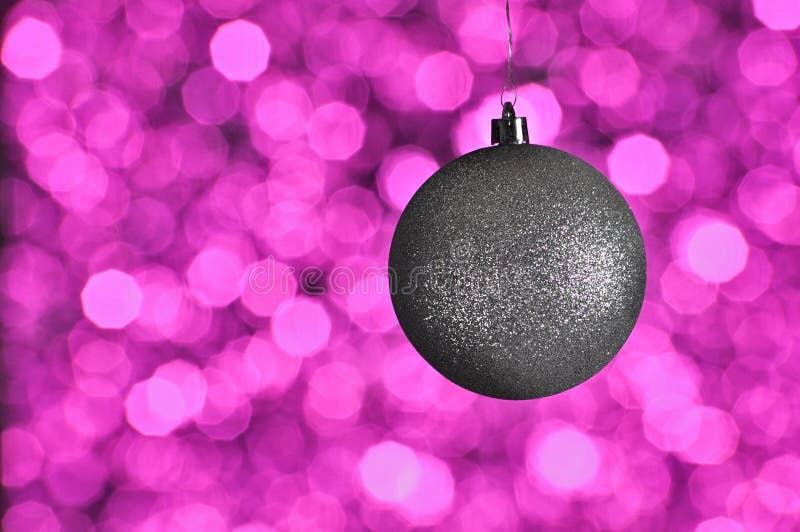 Elegant colored New Year and Christmas ball on the background with light effect and bokeh.Silver,red,lilac,purple,magenta. Elegant colored New Year and Christmas ball on the background with light effect and bokeh.Silver,red,lilac,purple,magenta