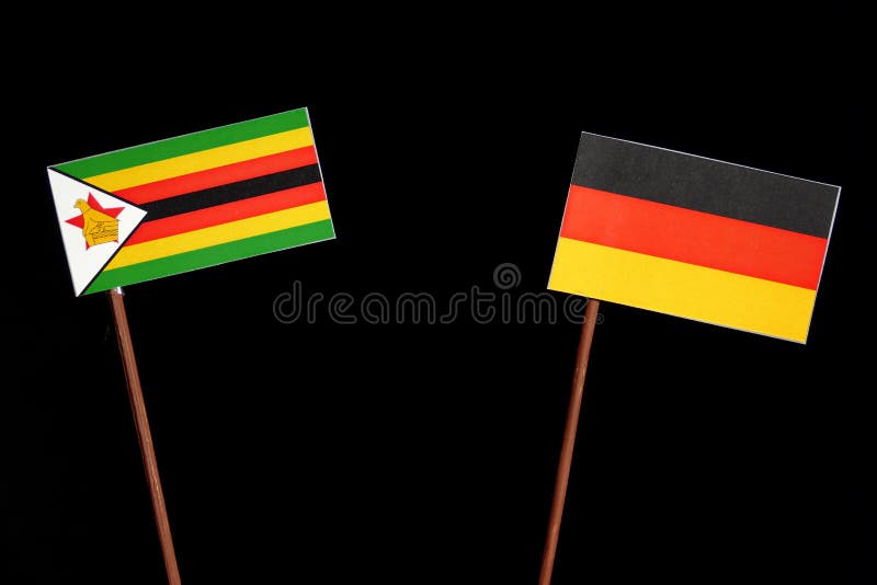 Zimbabwe flaga z niemiec flaga na czerni zdjęcia stock