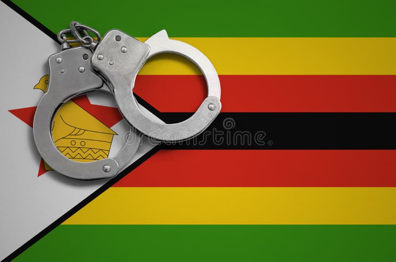 Zimbabwe polici i flaga kajdanki Pojęcie przestępstwo i przestępstwa w kraju zdjęcie royalty free