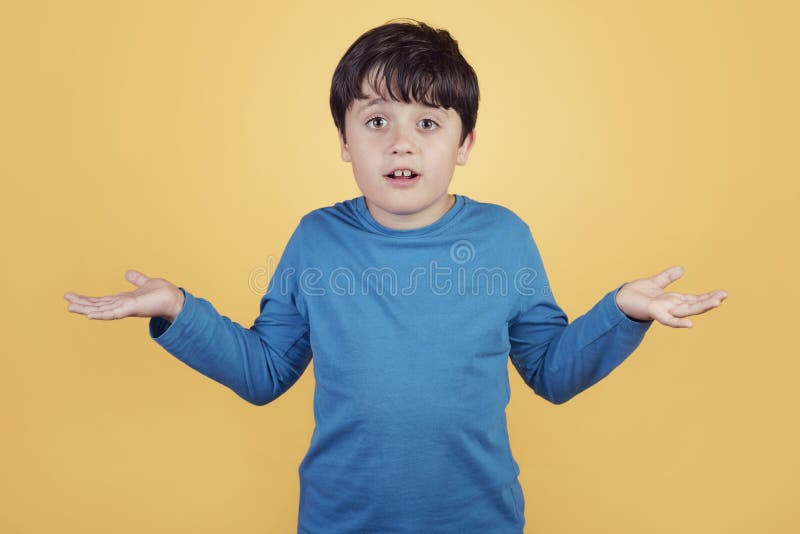 Confused child asking about on yellow background. Confused child asking about on yellow background