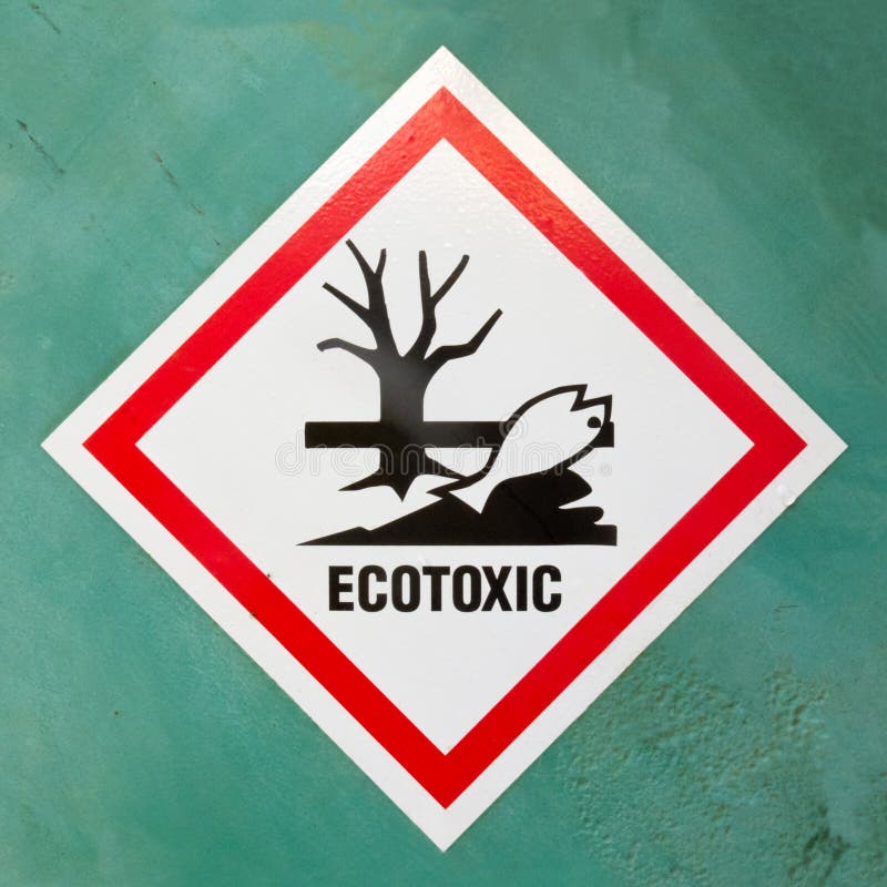 Dangerous for the environment hazard symbol or ecotoxic warning sign on a painted wall warning of lethal consequences to plant and animal life due to toxicity. Dangerous for the environment hazard symbol or ecotoxic warning sign on a painted wall warning of lethal consequences to plant and animal life due to toxicity