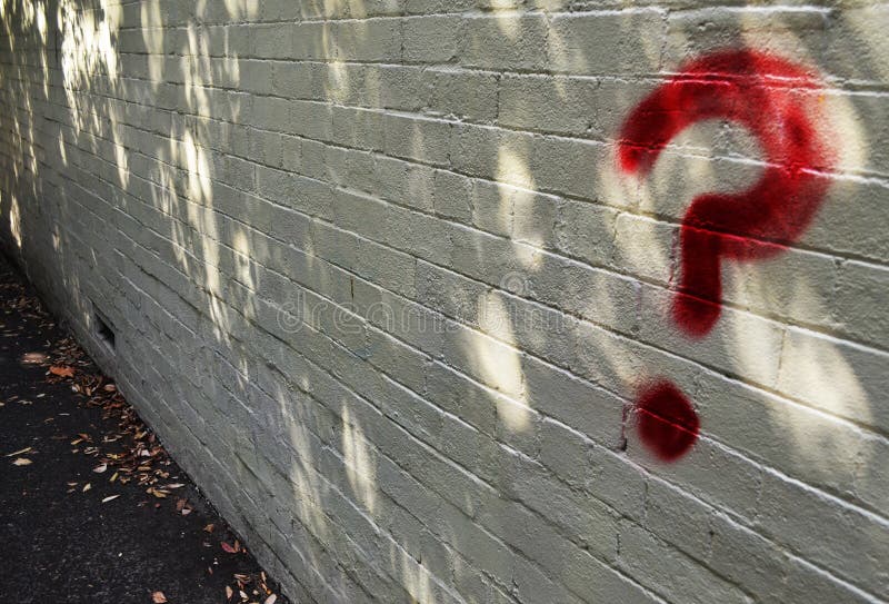 Red spray painted question mark on brick background with copy space. Red spray painted question mark on brick background with copy space