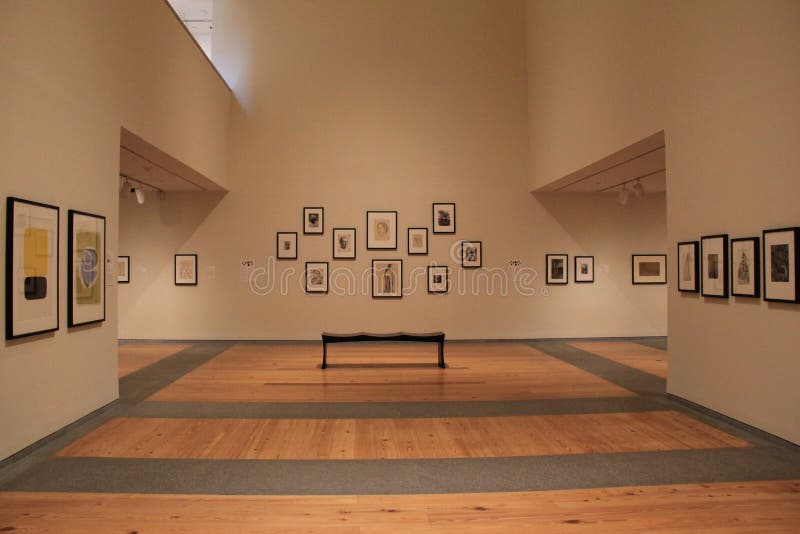 Beautiful area of open room, where numerous pieces of artwork adorn the walls and comfortable benches are placed for seating,Portland Art Museum,Maine,2016. Beautiful area of open room, where numerous pieces of artwork adorn the walls and comfortable benches are placed for seating,Portland Art Museum,Maine,2016.