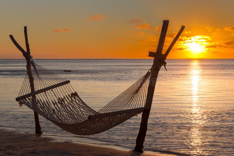 Hammock on the beach in front of the sunset in Le Morne, Mauritius, Africa. Hammock on the beach in front of the sunset in Le Morne, Mauritius, Africa.