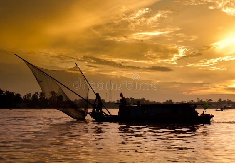 Fishing boat at sunrise on the Mekong river, Vietnam. Fishing boat at sunrise on the Mekong river, Vietnam