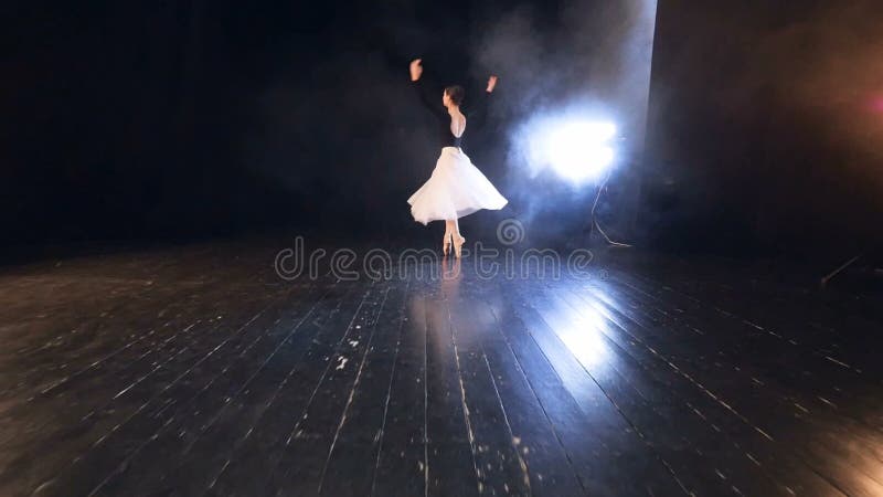 A zoomed up ballet dancer finishing up her performance with a bow.