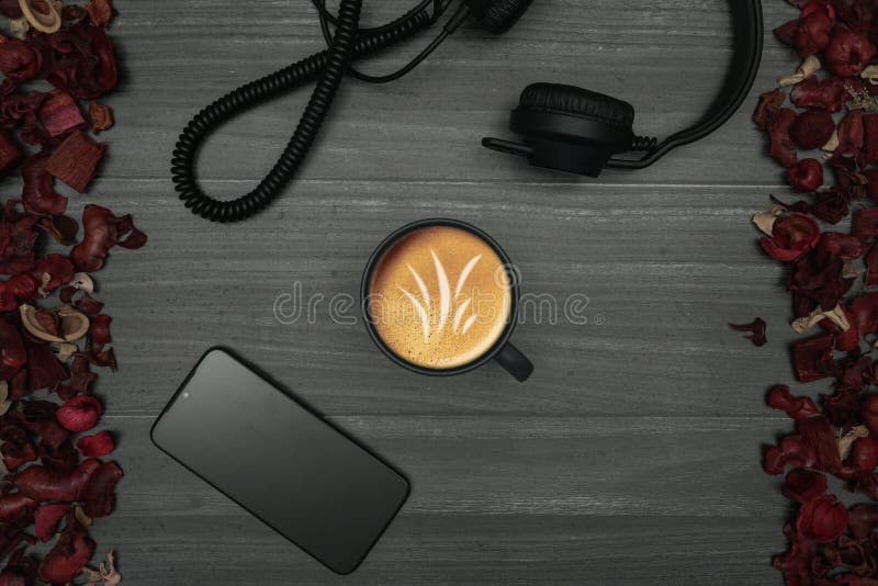 Wooden background with, cup of coffee, smartphone, headphones and dry red leaves. Wooden background with, cup of coffee, smartphone, headphones and dry red leaves