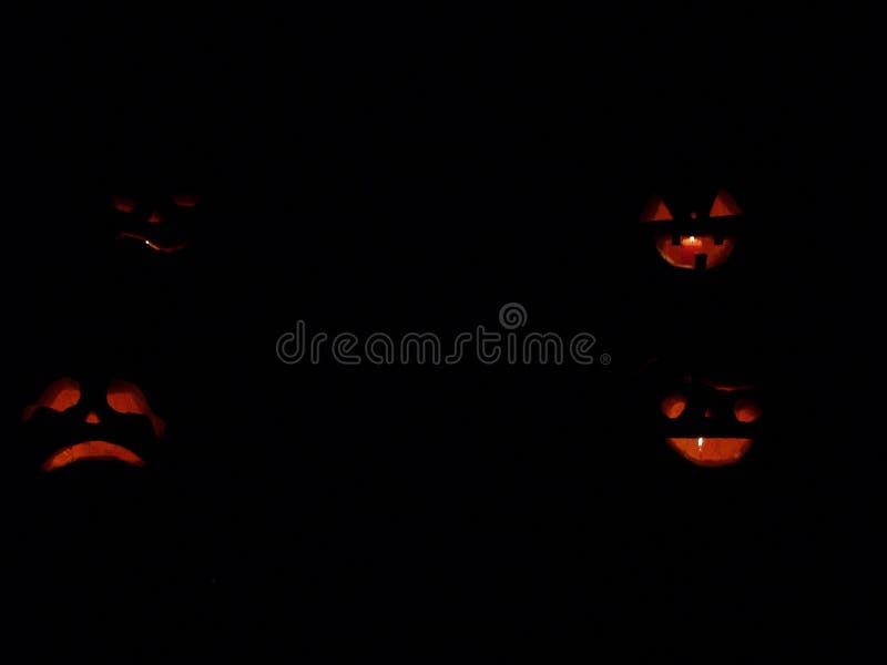 Zucche spaventose di Halloween isolate su un fondo nero scherzetto o dolcetto d'ardore dei fronti fotografia stock libera da diritti Zucche spaventose di Halloween isolate su un fondo nero scherzetto o dolcetto d'ardore dei fronti fotografia stock libera da diritti