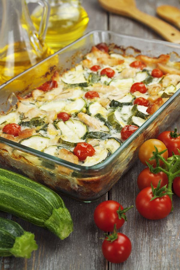 Zucchini baked i with chicken, cherry tomatoes and herbs