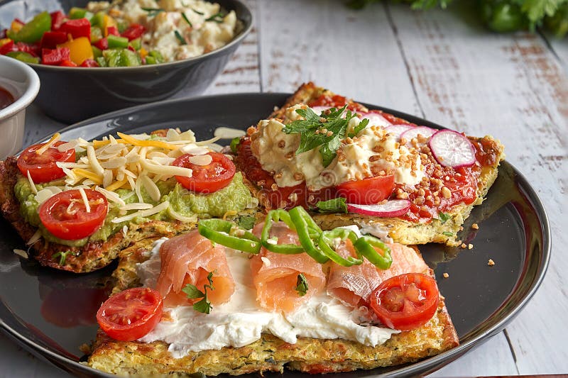 Cheese and zucchini tortillas, smoked salmon, radishes, cherry tomatoes, avocado cream, cream cheese, tomato cream with basil, par stock photo Cheese and zucchini tortillas, smoked salmon, radishes, cherry tomatoes, avocado cream, cream cheese, tomato cream with basil, par stock photo