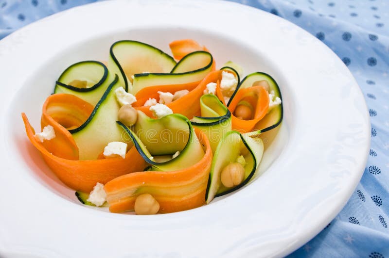 Zucchini salad with carrots, chickpeas and feta ch. Closeup with a zucchini salad with carrots, chickpeas and feta cheese stock image Zucchini salad with carrots, chickpeas and feta ch. Closeup with a zucchini salad with carrots, chickpeas and feta cheese stock image