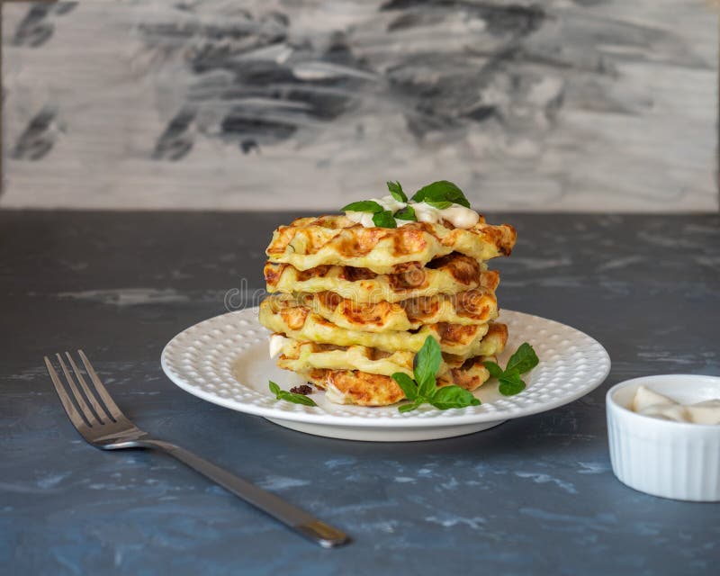 Zucchini Shoes with the Addition of Cheese on a Light Plate Top View