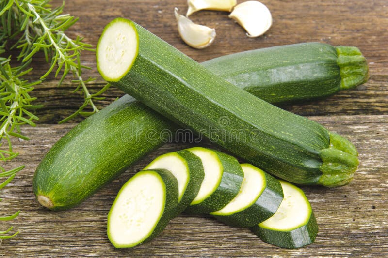 Zucchini vegetables. On old wooden table stock photos