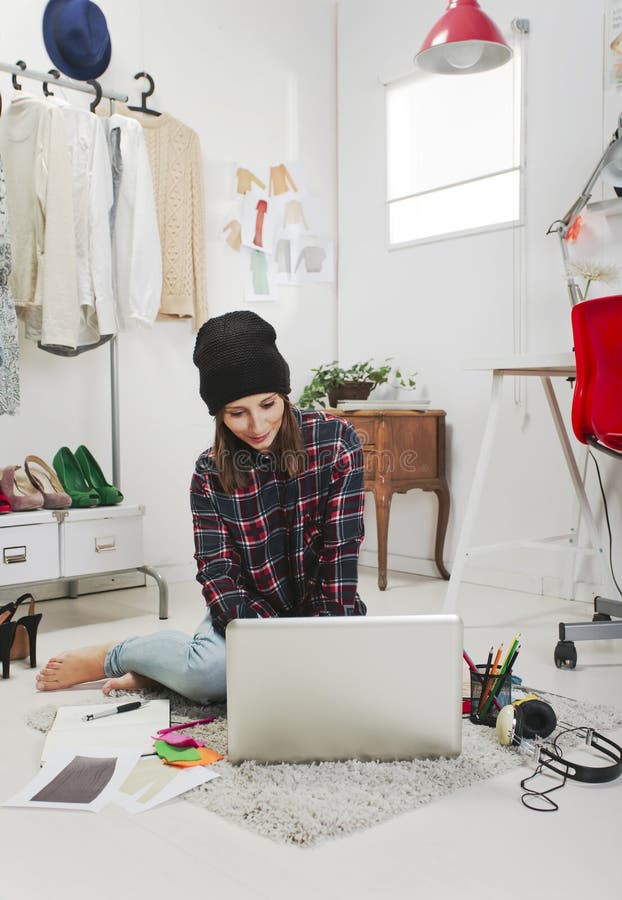 Zufällige Bloggerfrau, die in ihrem Modebüro arbeitet. stockbild Zufällige Bloggerfrau, die in ihrem Modebüro arbeitet. stockbild