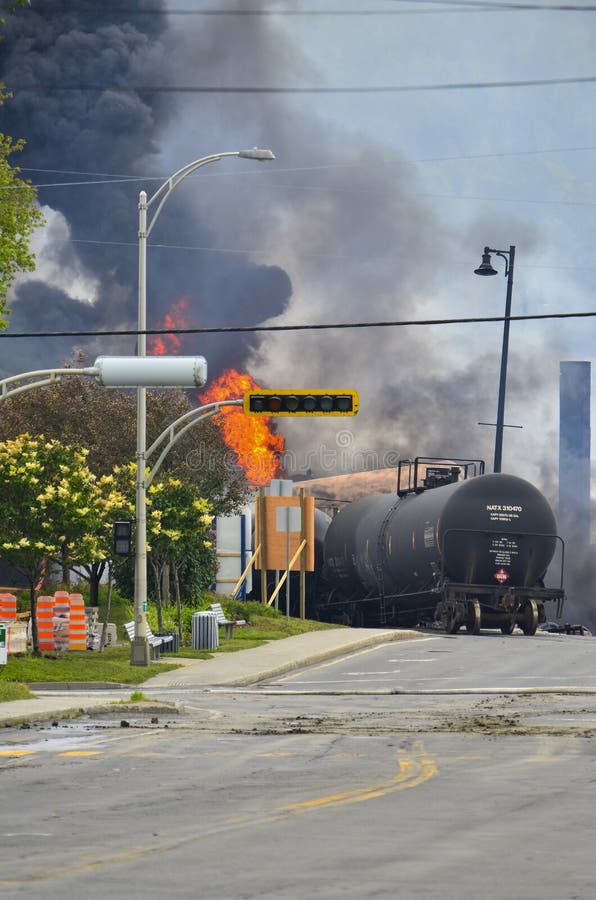 Derailed oil tanker train car on fire in Lac-Megantic, Quebec. Billowing smoke and flames rise from the remains. Derailed oil tanker train car on fire in Lac-Megantic, Quebec. Billowing smoke and flames rise from the remains.