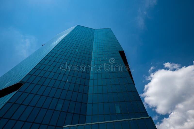 Zurich Prime Tower skyscraper green glass office building. Low wide angle view, sunny summer day, blue sky, no people