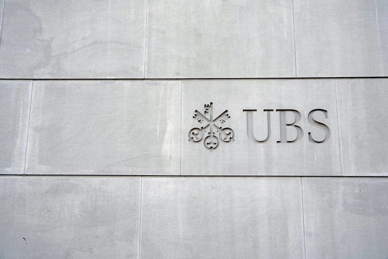 Zurich, Switzerland - 12 20 2020: Logo of a Swiss bank UBS sculpted on the stone wall of building in city center of Zurich, on Bahnhofstrasse, the most expensive street in town. Zurich, Switzerland - 12 20 2020: Logo of a Swiss bank UBS sculpted on the stone wall of building in city center of Zurich, on Bahnhofstrasse, the most expensive street in town.