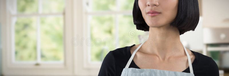 Waitress standing against white background against empty kitchen with vegetables and mixer. Waitress standing against white background against empty kitchen with vegetables and mixer