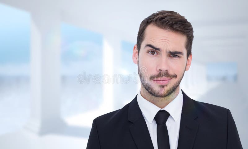 Portrait of a skeptical businessman well dressed against bright white room with columns. Portrait of a skeptical businessman well dressed against bright white room with columns