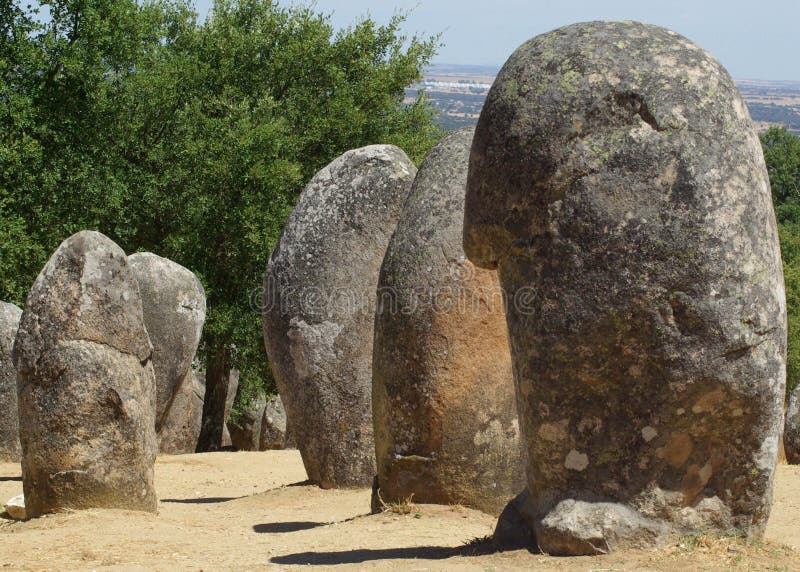 Long rows of standing stone megaliths at neolithic site in southern Portugal cast shadows in the late summer sun. Long rows of standing stone megaliths at neolithic site in southern Portugal cast shadows in the late summer sun.