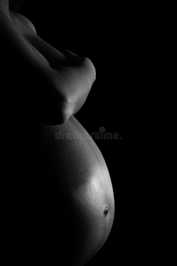 Pregnant belly on black background. Pregnant belly on black background