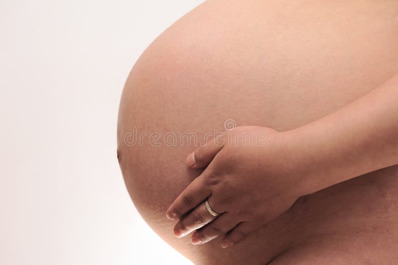 Pregnant woman touching her belly,a beautiful full term pregnant belly. Pregnant woman touching her belly,a beautiful full term pregnant belly