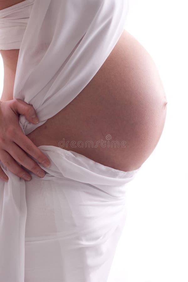 Close up studio shot of a beautiful full term pregnant belly. Close up studio shot of a beautiful full term pregnant belly