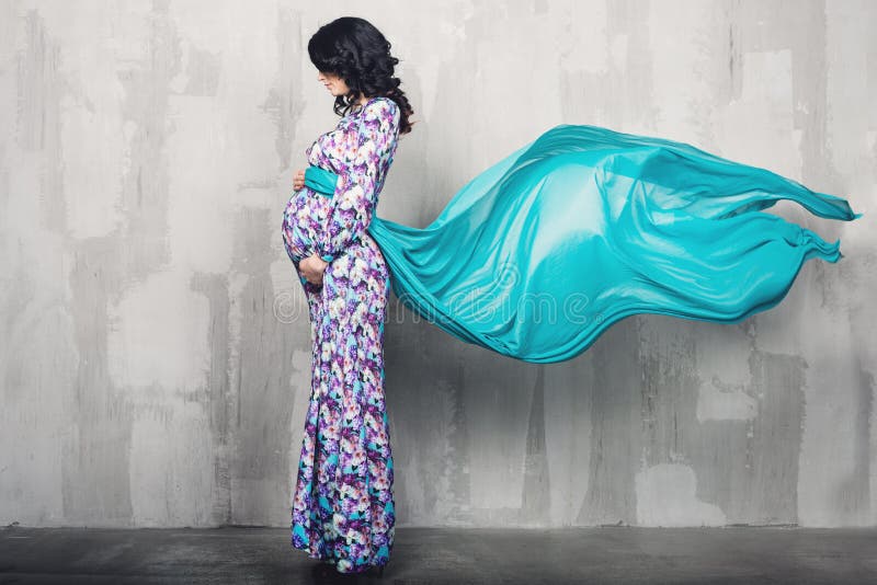 Zwangere vrouw over grijze achtergrond royalty-vrije stock fotografie Zwangere vrouw over grijze achtergrond royalty-vrije stock fotografie
