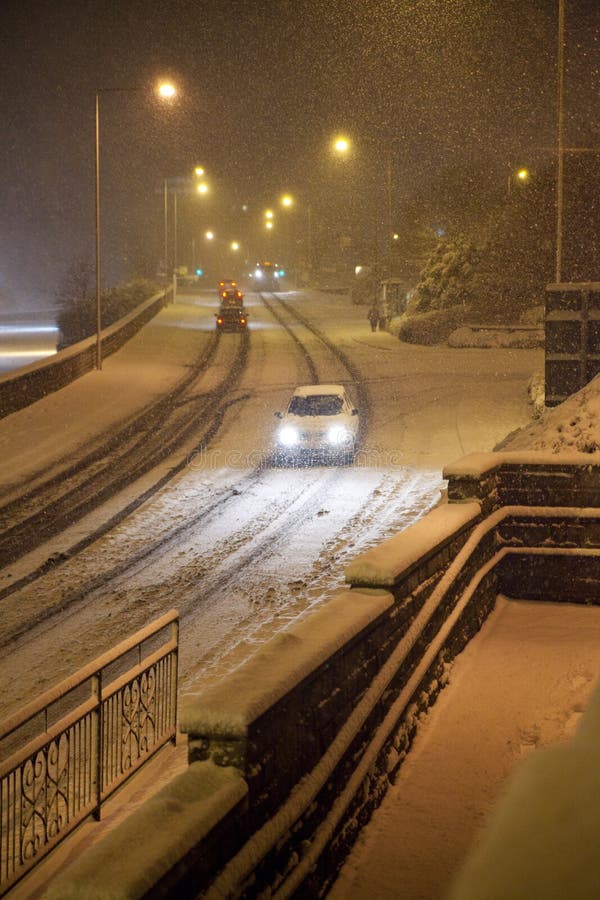 Heavy snow fall at night with passing traffic. Heavy snow fall at night with passing traffic