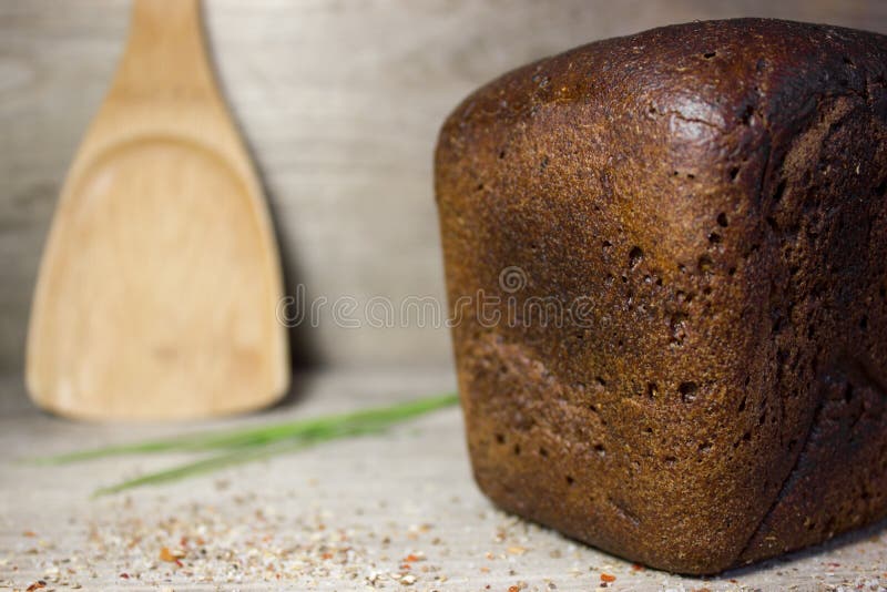 Black rye bread on wooden background. Black rye bread on wooden background.