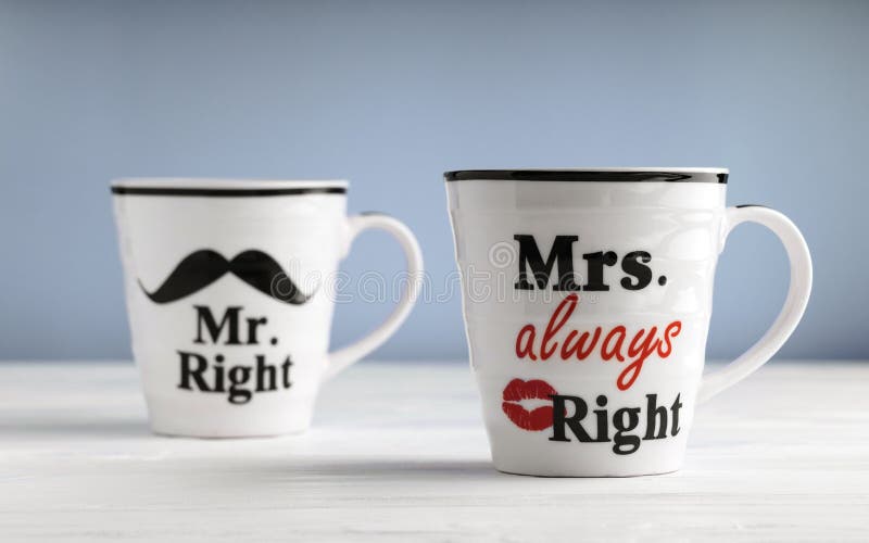 Two mugs with printed text Mr. right and Mrs. always right. Funny phrase about couples life printed on mug. Two mugs with printed text Mr. right and Mrs. always right. Funny phrase about couples life printed on mug