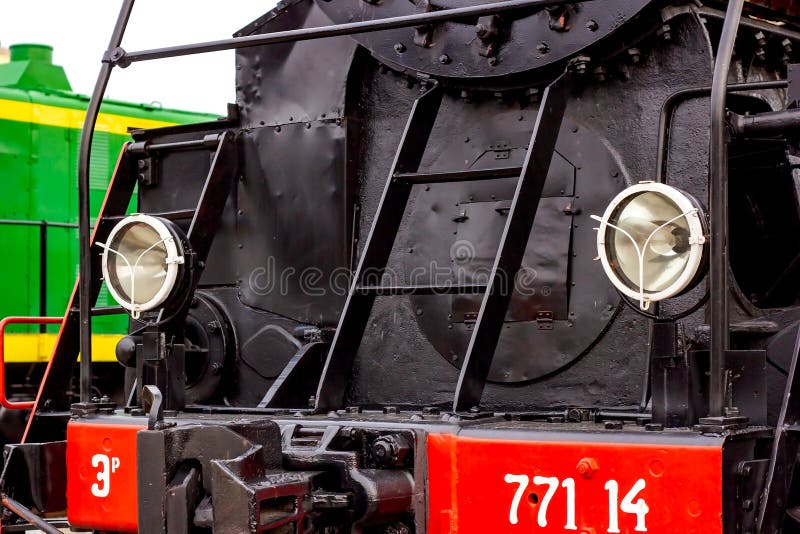 Zwei elektrische Scheinwerfer an einer Vorderseite des Retrozugs auf der Bahnsteig schließen. stockfoto