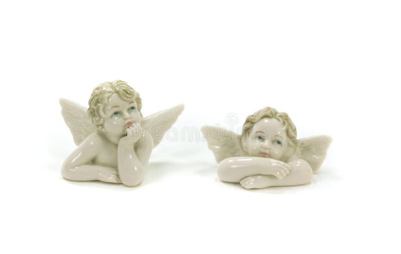 Two small statuettes of angels with wings on a white background. Two small statuettes of angels with wings on a white background