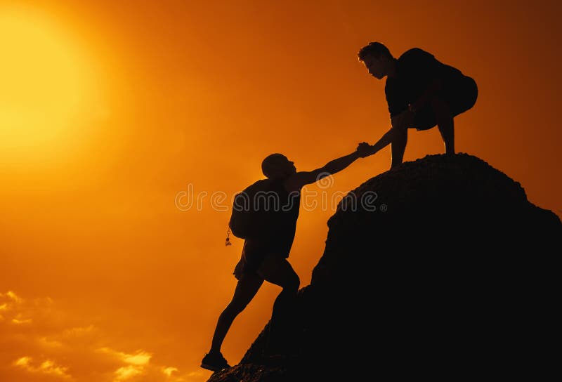Two friends climbing on mountain peak on sunset outdoors in summer. Two friends climbing on mountain peak on sunset outdoors in summer