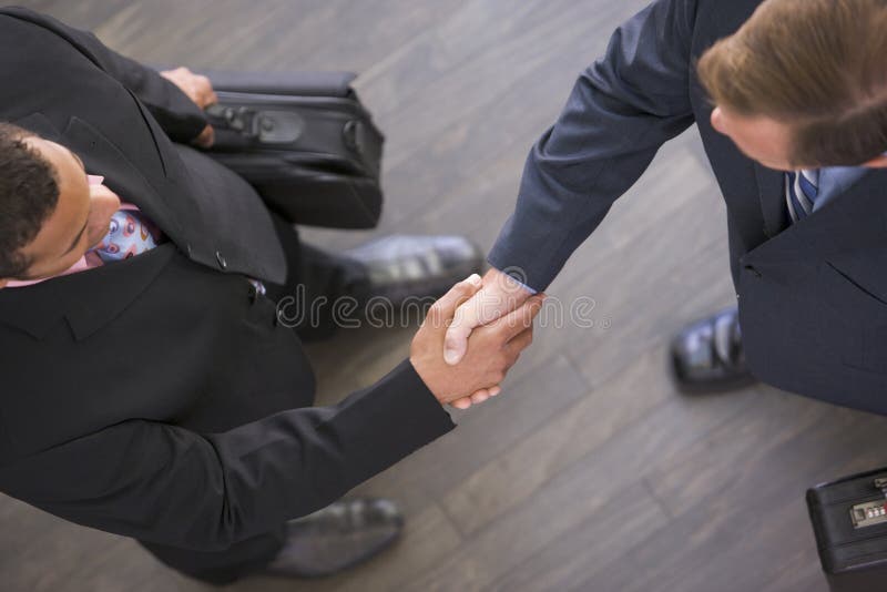 Zwei Geschäftsmänner, die zuhause Hände rütteln