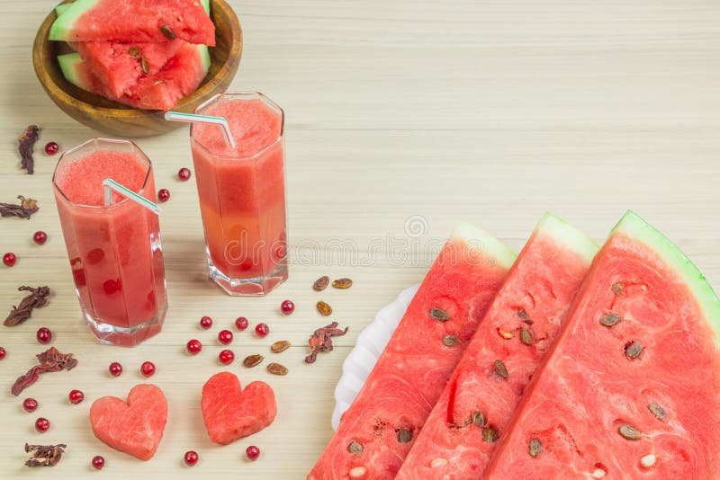 Zwei Herzen, Wassermelonensaft in zwei Glasschalen mit einem Stroh auf einem hellen hölzernen Hintergrund, ein köstliches Cocktai stockfoto Zwei Herzen, Wassermelonensaft in zwei Glasschalen mit einem Stroh auf einem hellen hölzernen Hintergrund, ein köstliches Cocktai stockfoto