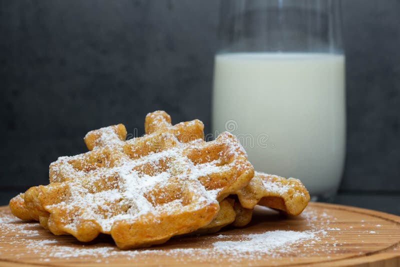 Zwei Karottenwaffeln besprüht mit Puderzucker auf einem hölzernen Brett Selbst gemachte Waffeln auf einer hölzernen Platte Im Hin stockfoto Zwei Karottenwaffeln besprüht mit Puderzucker auf einem hölzernen Brett Selbst gemachte Waffeln auf einer hölzernen Platte Im Hin stockfoto