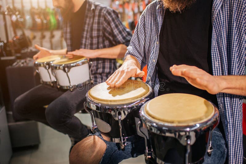 Zwei Kerle, die Schlag auf afrikanischen Trommeln haben Sie sitzen und spielen zusammen auf Instrumenten stockbild Zwei Kerle, die Schlag auf afrikanischen Trommeln haben Sie sitzen und spielen zusammen auf Instrumenten stockbild