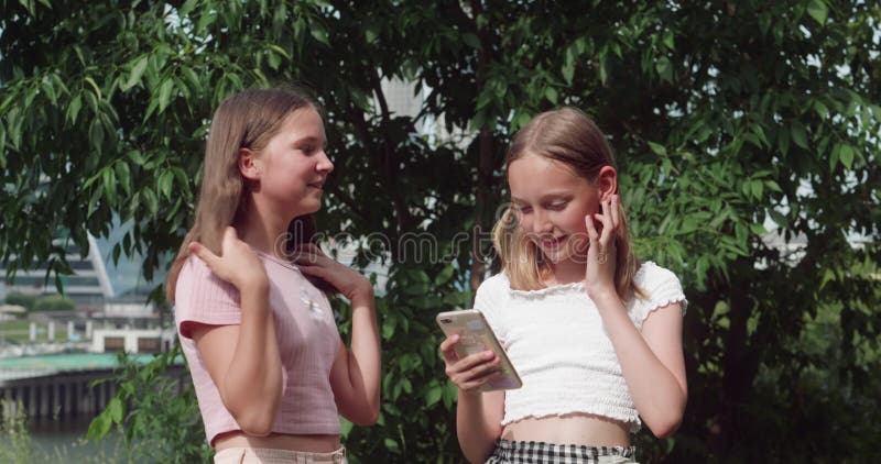 Two Smiling Young Girls, The Outdoor Mobile Phone Use Stock Footage - Summer Time Video, Nice: 230924100 [0: 13x306p]     