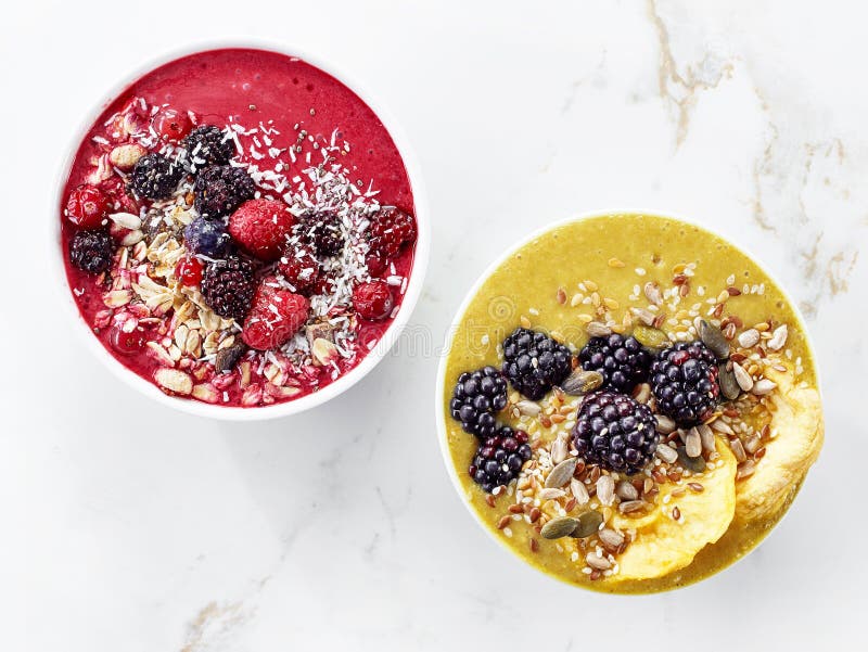Two bowls of breakfast smoothie, top view. Two bowls of breakfast smoothie, top view