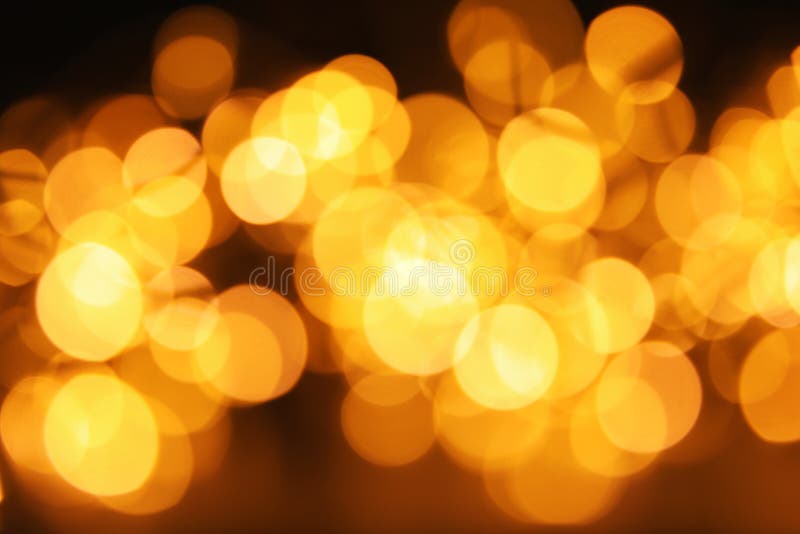Złocista błyskotliwość z bokeh skutkiem na zmroku obraz royalty free