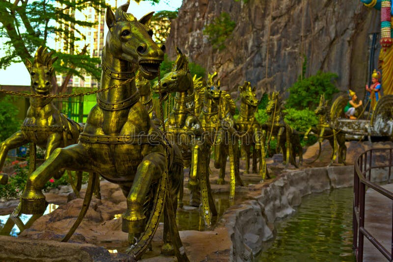 Golden horses in Batu Caves Gombak Selangor Malaysia in front of Krishna statue. Golden horses in Batu Caves Gombak Selangor Malaysia in front of Krishna statue